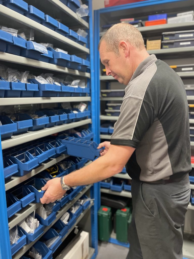 Optimax engineer selecting stores from a large storage unit